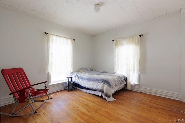 bedroom featuring crown molding and light hardwood / wood-style floors