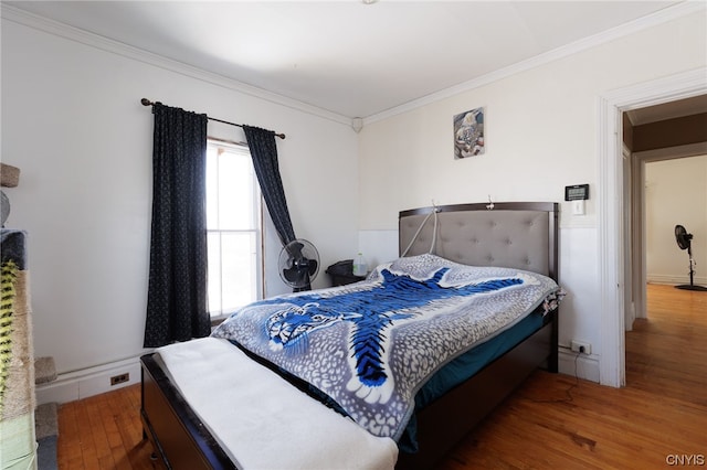 bedroom featuring wood-type flooring and crown molding