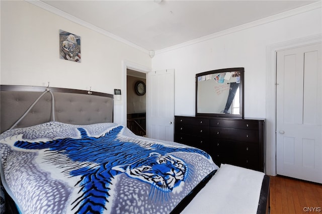 bedroom featuring dark hardwood / wood-style flooring and crown molding