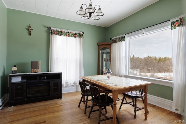 dining room featuring plenty of natural light, an inviting chandelier, and light wood-type flooring