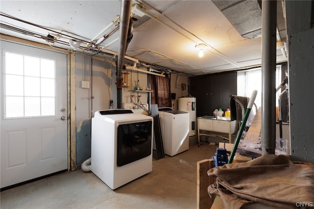 basement featuring washing machine and clothes dryer and electric water heater