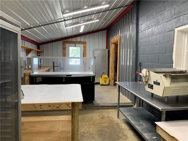 kitchen with concrete flooring and vaulted ceiling