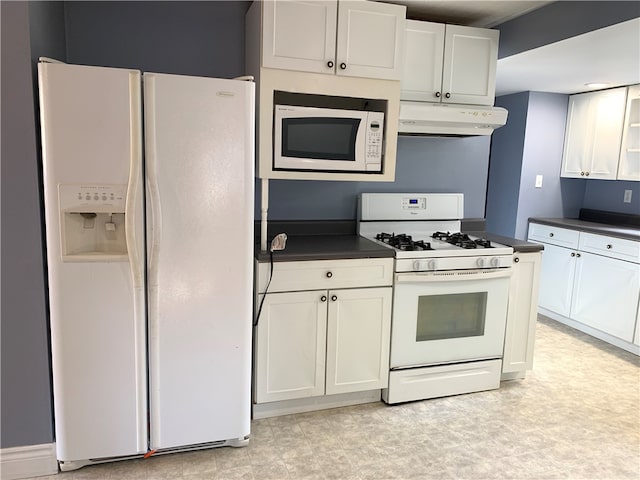 kitchen with white cabinets, light tile patterned floors, and white appliances