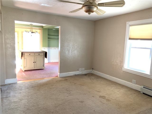 unfurnished room with ceiling fan, carpet flooring, and a baseboard heating unit