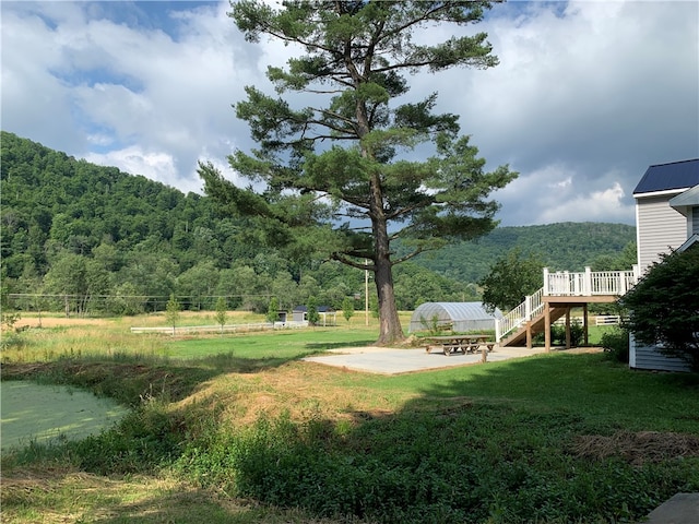 view of yard featuring a deck and a patio area