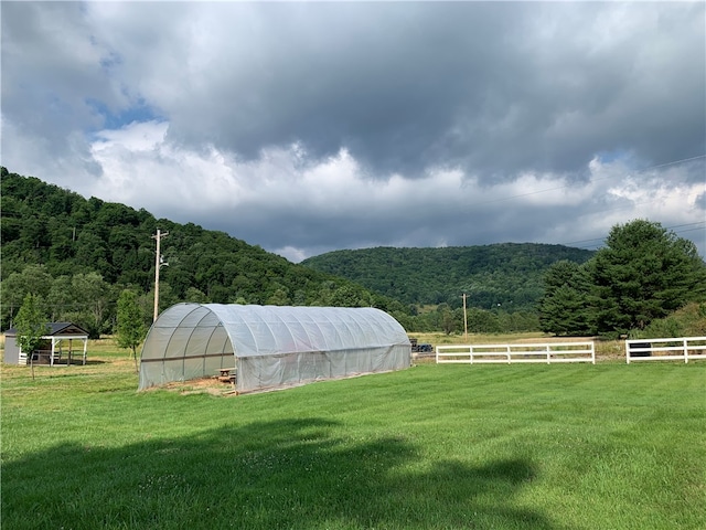 view of yard with an outdoor structure and a rural view