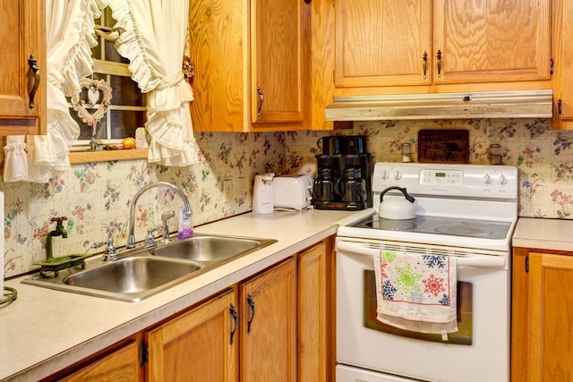 kitchen with white range with electric stovetop and sink