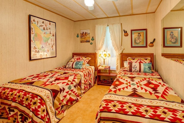 bedroom featuring a textured ceiling, ceiling fan, and light carpet