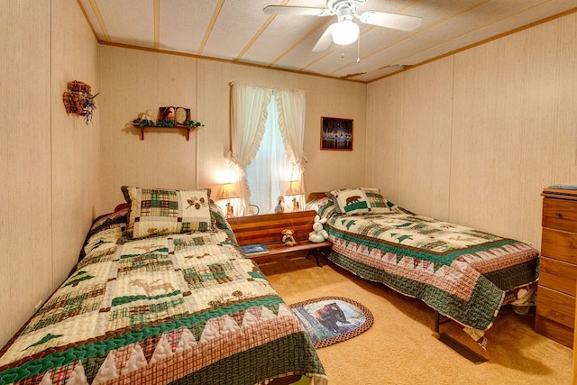 carpeted bedroom with ceiling fan, crown molding, and a textured ceiling