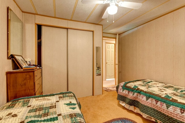 carpeted bedroom featuring a textured ceiling, a closet, and ceiling fan