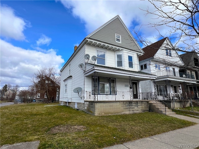 view of front of home with covered porch and a front yard