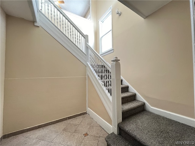 stairway with light tile floors