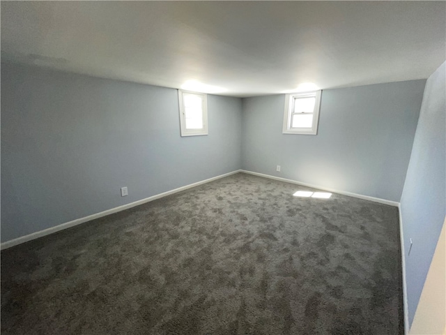 basement featuring dark colored carpet