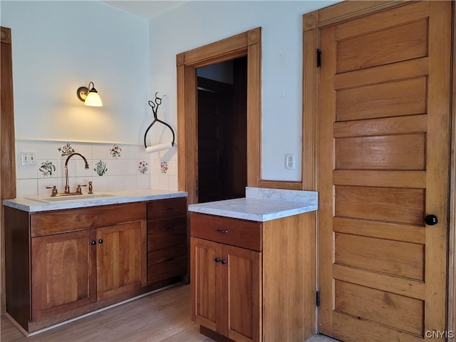 bathroom featuring tasteful backsplash, vanity, and hardwood / wood-style flooring