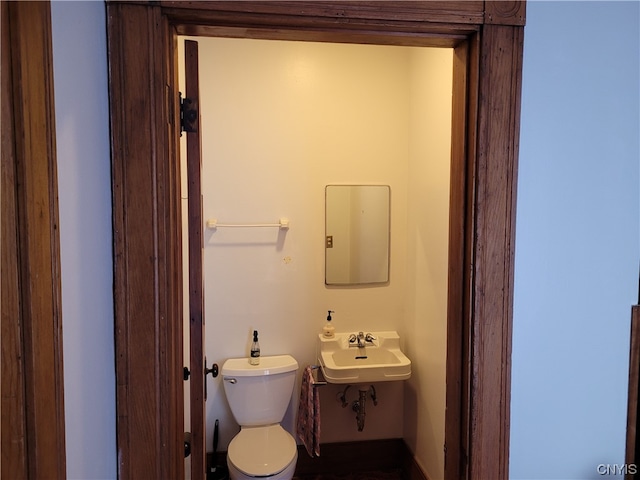 bathroom featuring toilet and sink