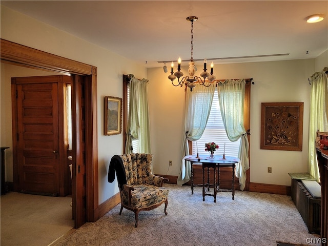 sitting room featuring carpet flooring and a notable chandelier