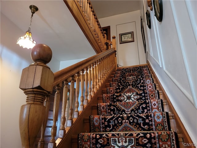 stairway featuring a towering ceiling