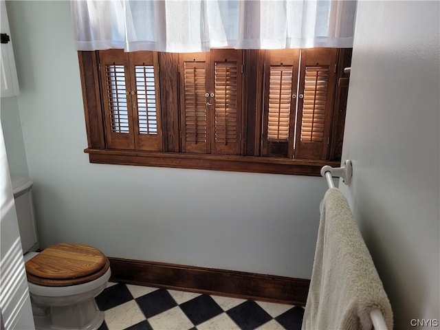 bathroom with tile flooring and toilet