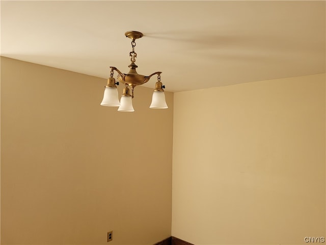 spare room with a notable chandelier