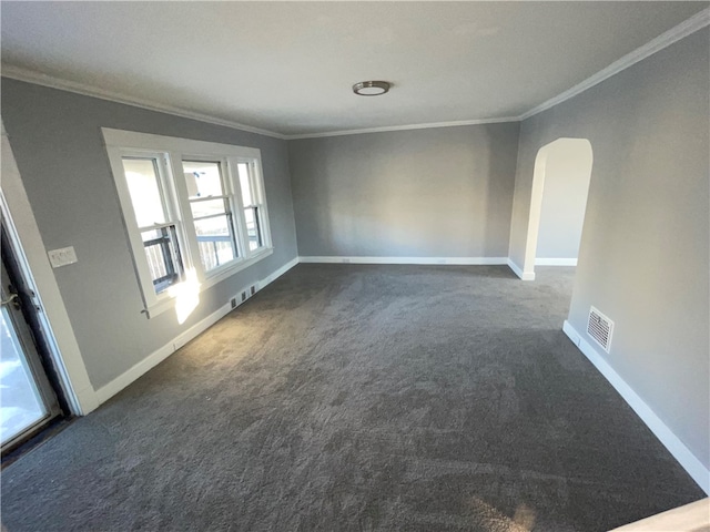 carpeted empty room featuring crown molding