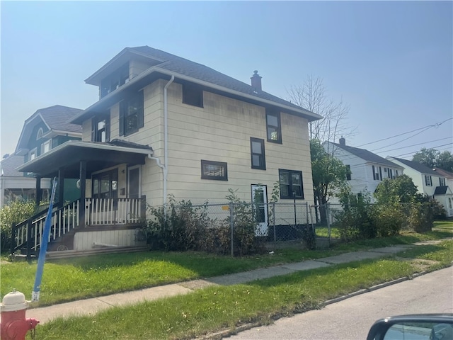 view of side of property with a porch