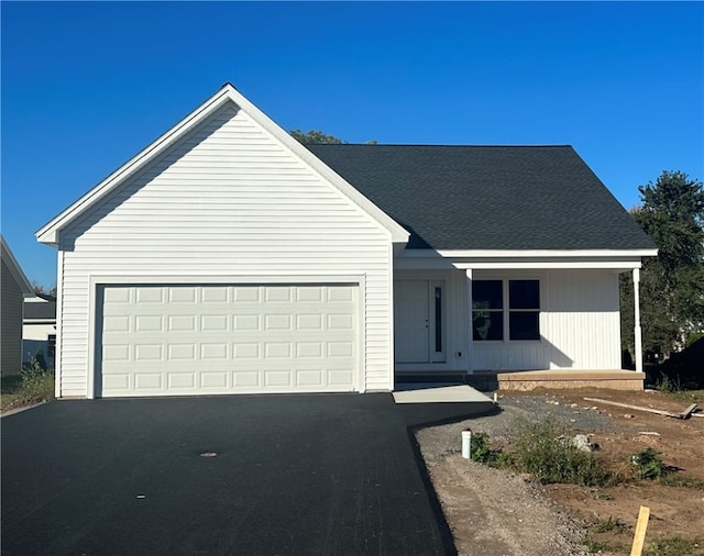 view of front of house with a porch and a garage