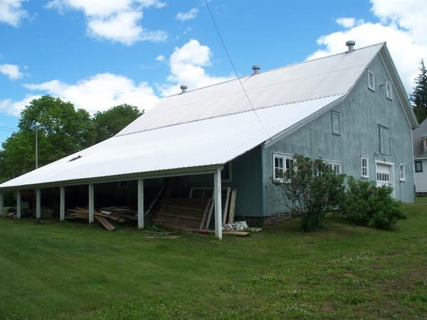 rear view of house featuring a yard