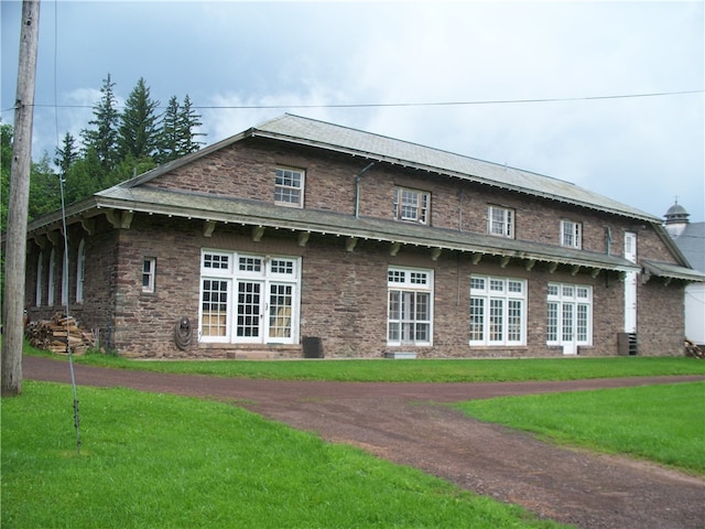 view of front facade featuring a front yard and french doors