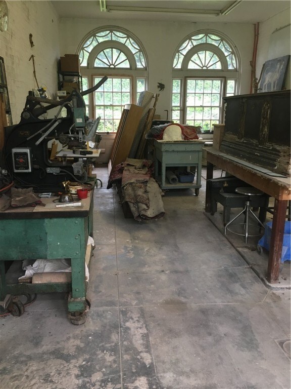 misc room with concrete flooring and a wealth of natural light