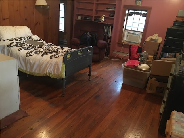 bedroom featuring wood walls and dark hardwood / wood-style floors