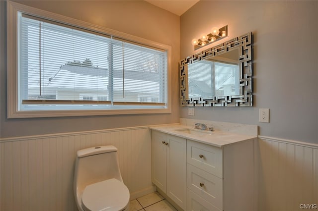 bathroom featuring tile floors, vanity, and toilet