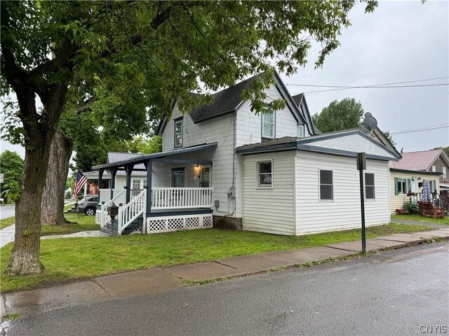 view of front facade featuring covered porch and a front lawn