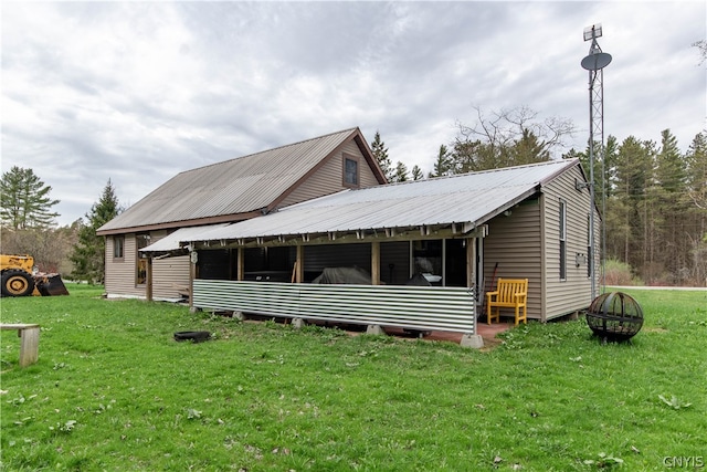 back of property featuring a yard