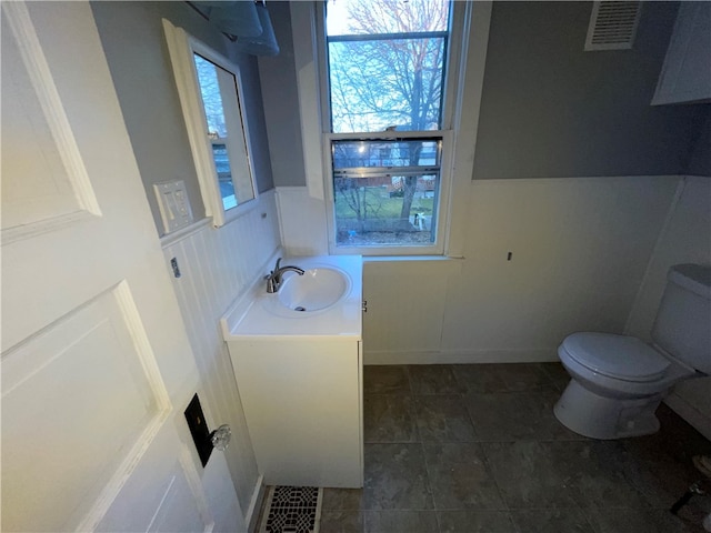 bathroom featuring vanity and toilet