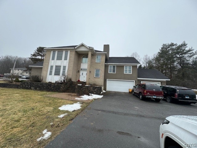 view of front property with a front lawn and a garage