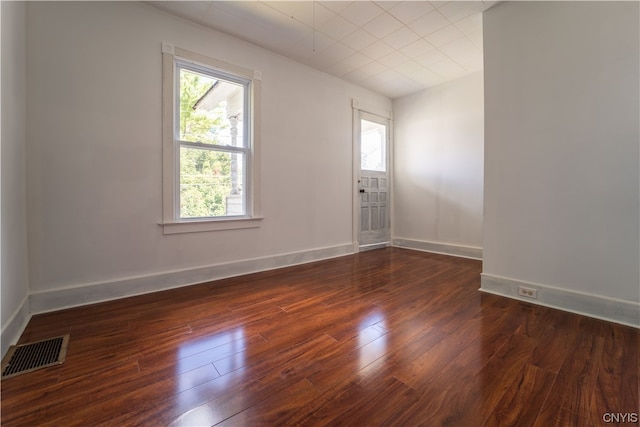 spare room with dark wood-type flooring