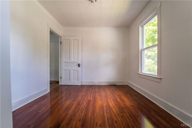 empty room featuring dark wood-type flooring