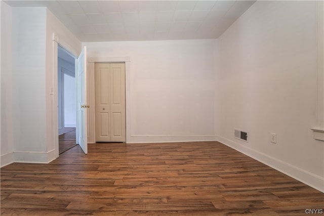 unfurnished room featuring dark hardwood / wood-style floors