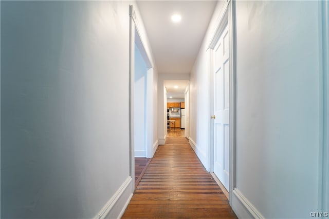 corridor featuring dark hardwood / wood-style flooring