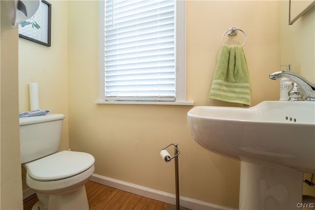 bathroom with toilet and hardwood / wood-style flooring