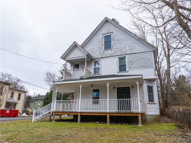 view of front of property featuring covered porch and a front lawn