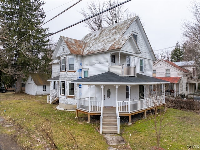 back of property with a yard and a porch