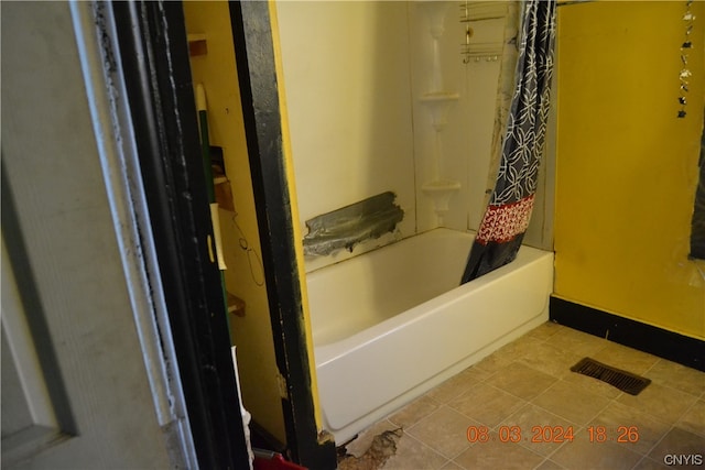 bathroom featuring tile floors and shower / bath combo with shower curtain