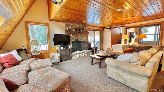 carpeted living room with wooden walls, a wealth of natural light, and wooden ceiling