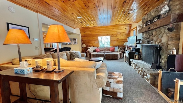 living room featuring carpet flooring, a stone fireplace, wooden ceiling, and wood walls