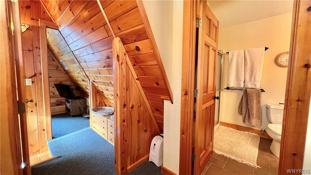 hall featuring wood ceiling, vaulted ceiling, and wood walls