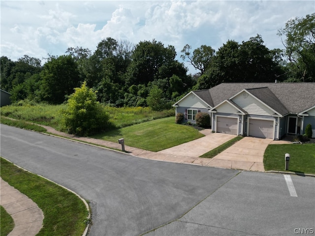 view of front of home featuring a front lawn and a garage