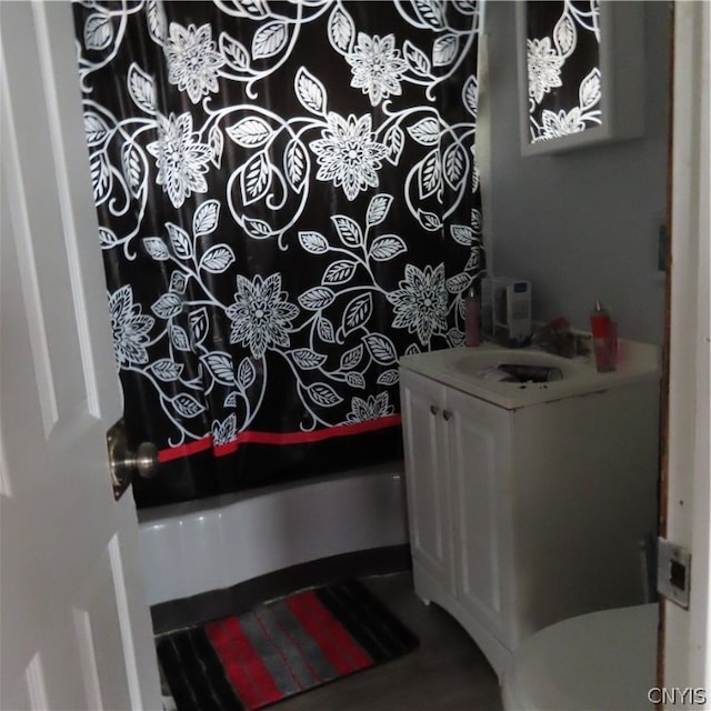 full bathroom featuring vanity, shower / tub combo with curtain, and toilet