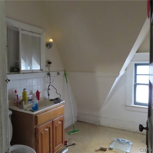 bathroom featuring toilet and vaulted ceiling