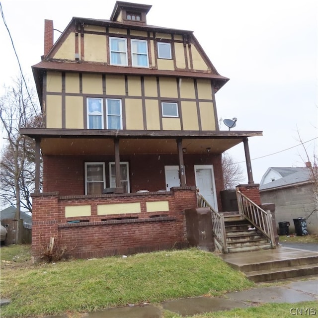 tudor-style house with covered porch